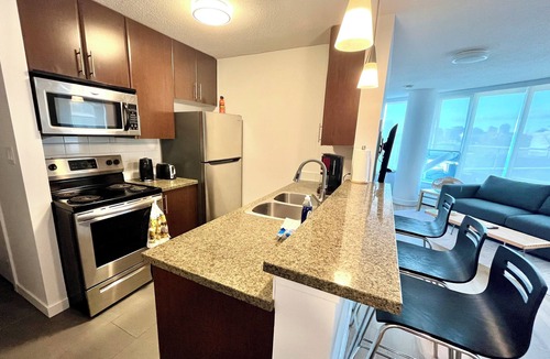 Crosstown Apartment | 1 bedroom + Sofabed, Private 500sqft sun deck, EV Parking w/Pool, Sauna, Hot Tub