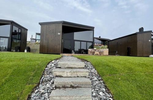 Nes Municipality House | Attraktiv & smart funkishytte på Nes Strandhager.