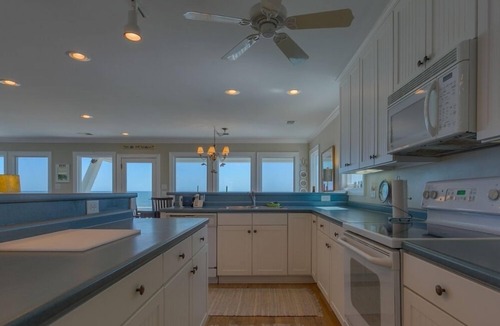 Holden Beach House | Bee Holden - Enjoy the beautiful Atlantic ocean from the deck while relaxing on the porch swing