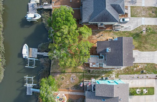 Long Beach House | Oak Island home on the Davis Canal with private boat dock.