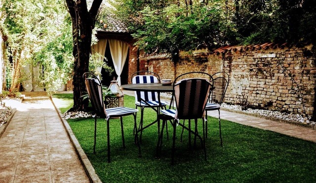 A garden in the shadow of the Torrazzo