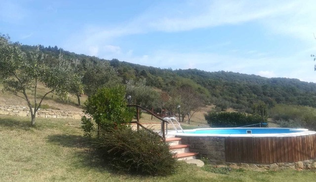 Detached stone view cottage with swimming pool and fenced garden.