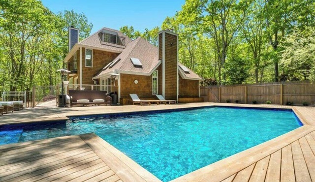 Stunning shingled Water Mill estate featuring a private heated pool and.