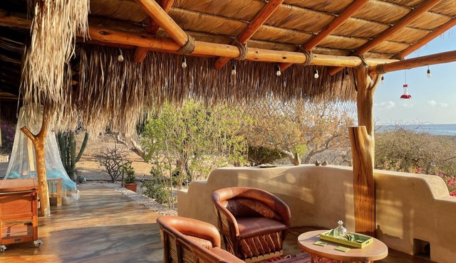 Traditional stone palapa retreat with ocean and desert views