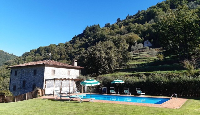 Very large house, surrounded by green, sunny, whit a private pool.
